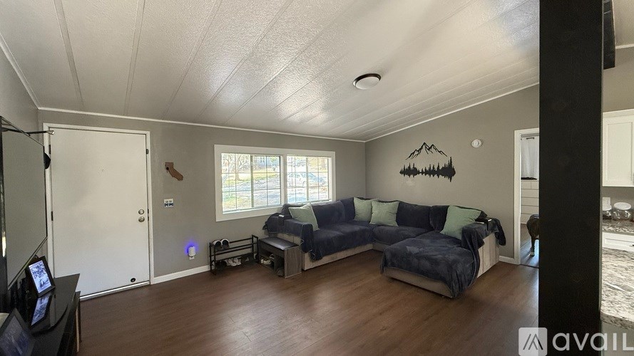 A living room with a couch and a television.