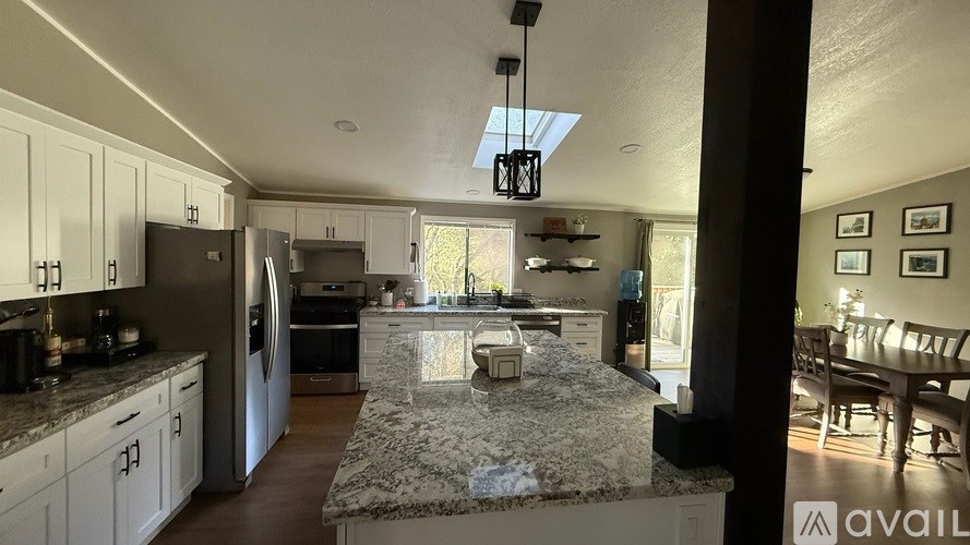 A kitchen with granite countertops and stainless steel appliances.
