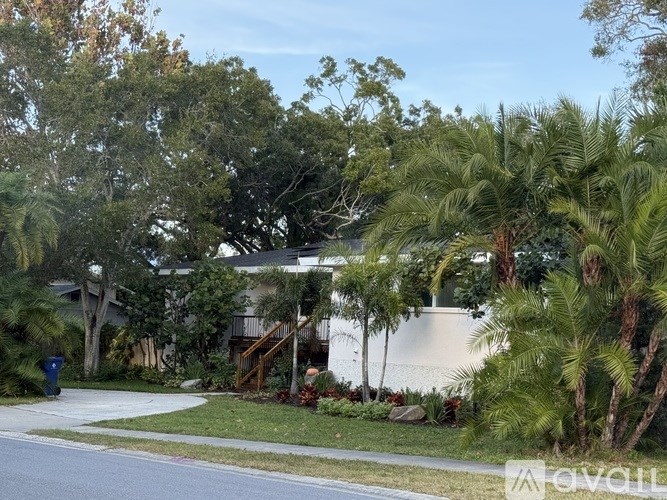 A house with a white fence and a green lawn.