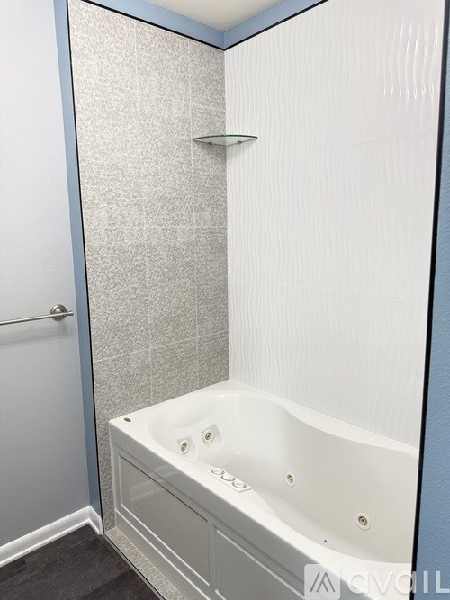 A white bathtub with a glass shower door.