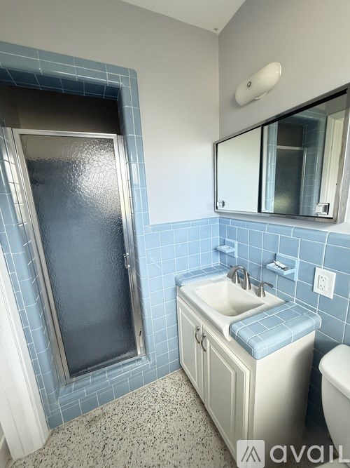 A bathroom with a sink, toilet and shower.