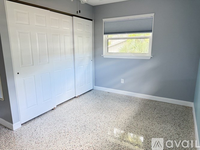 A room with a window and a door.