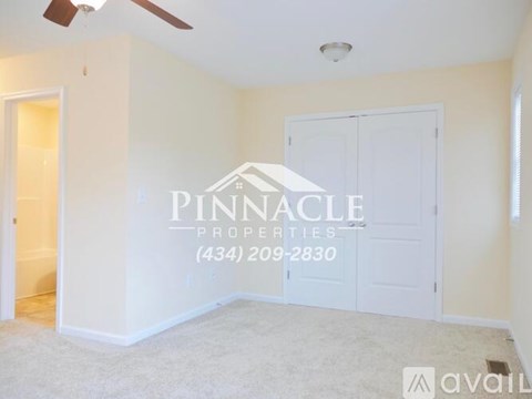 A room with a Pinnacle Properties sign and a phone number on the wall.
