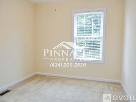 A room with a window and a carpet on the floor.