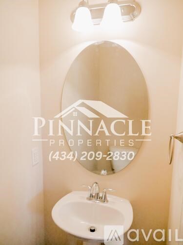 A bathroom with a sink and mirror and a sign that says Pinnacle Properties.