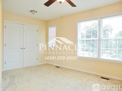 A room with a Pinnacle Properties sign and a phone number on the wall.