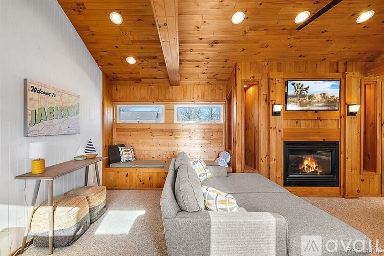 A cozy living room with a fireplace and a couch.