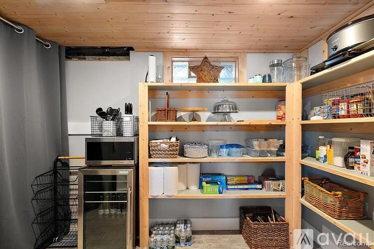 A kitchen with wooden shelves and baskets filled with items.