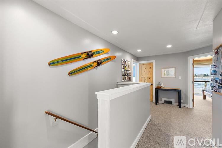 A room with a pair of skis hanging on the wall.