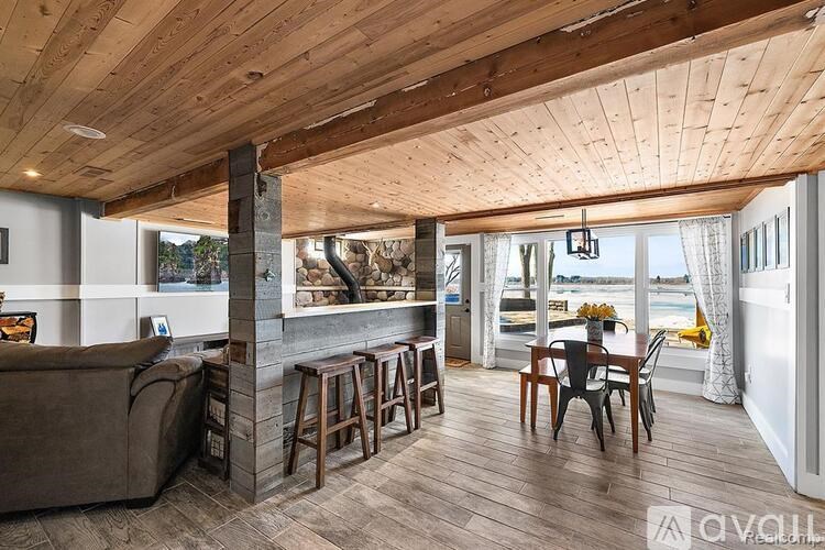 A living room with a couch, chairs, and a fireplace.
