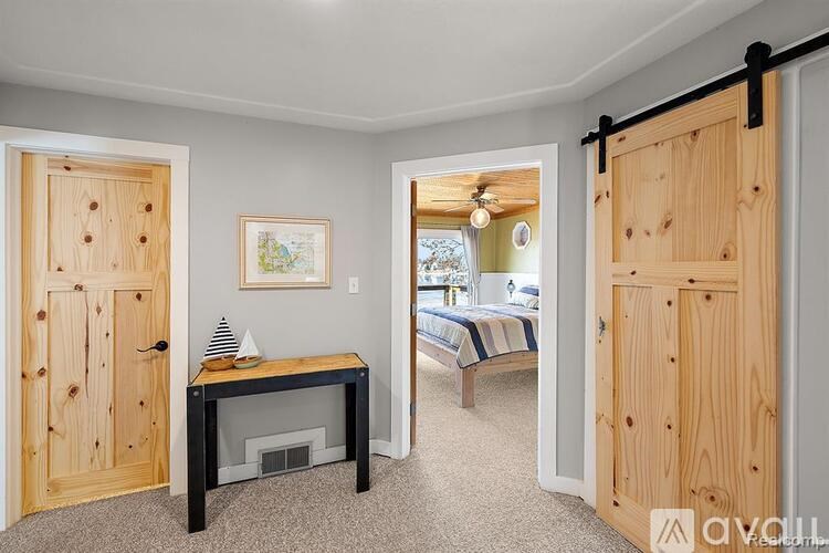 A room with a bed and a table in it.