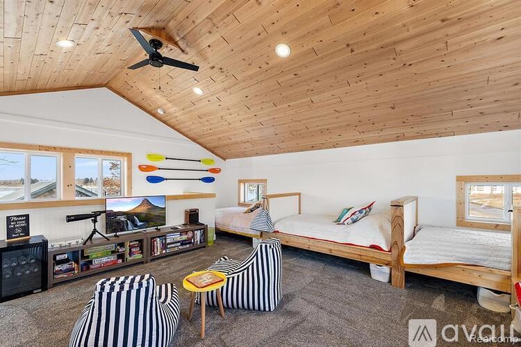 A room with a bed, a couch, and a television.