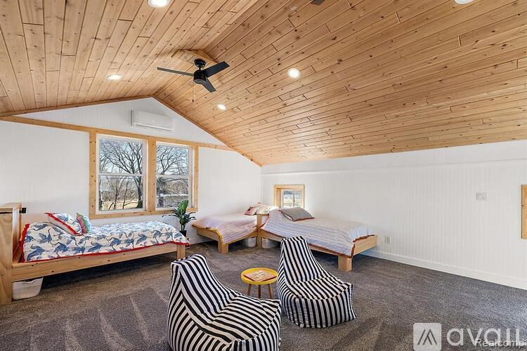 A bedroom with two beds and a ceiling fan.