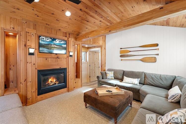 A cozy living room with a fireplace and a television.