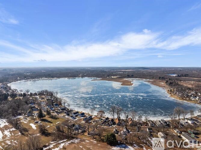 A small town with a large lake in the middle of it.