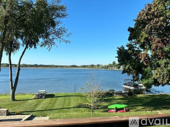 A serene lakeside scene with a boat docked on the shore.
