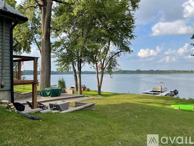 A house with a deck overlooking a lake.