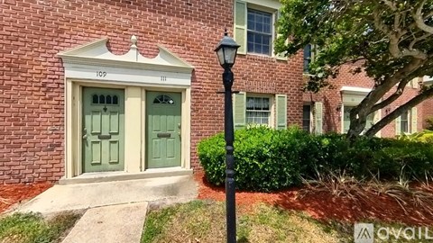 A house with a green door and a lamp post in front.