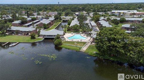 A bird's eye view of a resort with a swimming pool and buildings.