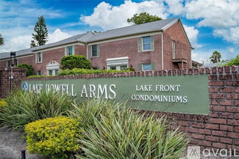 Lake front condominiums sign in front of a brick building.