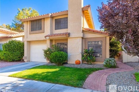 A house with a red brick walkway in front of it.