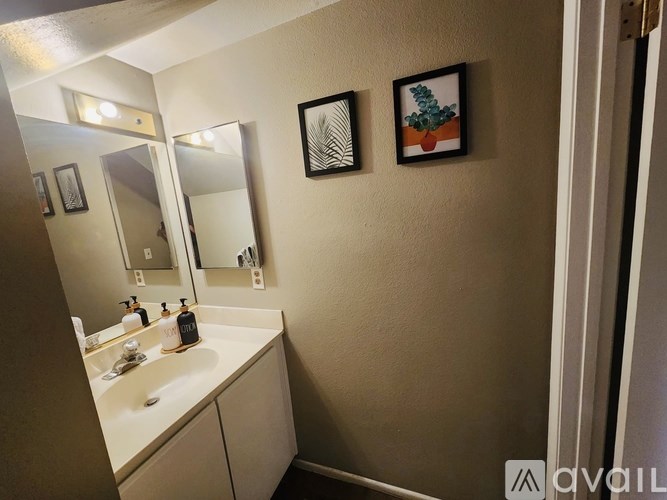 A bathroom with a white sink and a mirror above it.