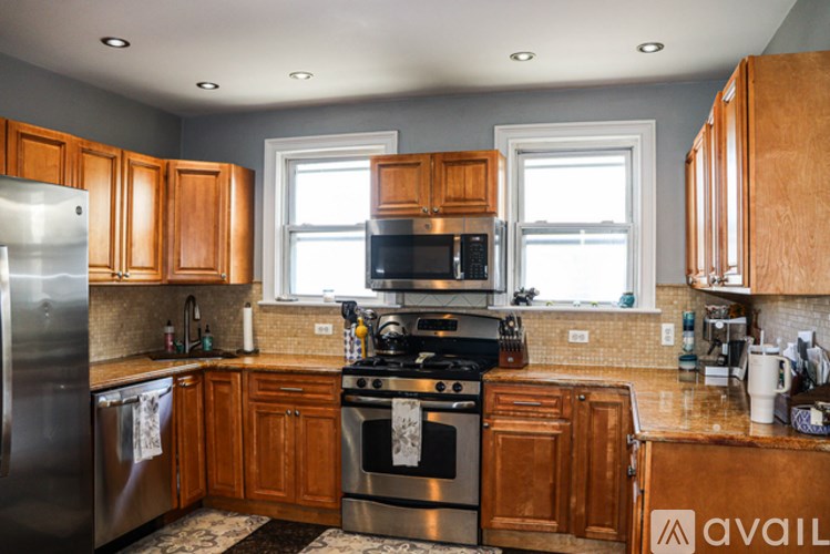 A kitchen with wooden cabinets and stainless steel appliances.