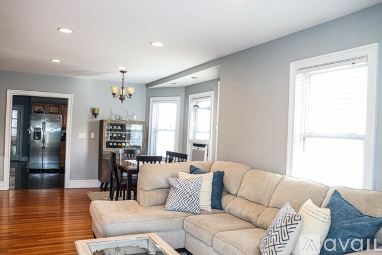 A living room with a couch and a chandelier.