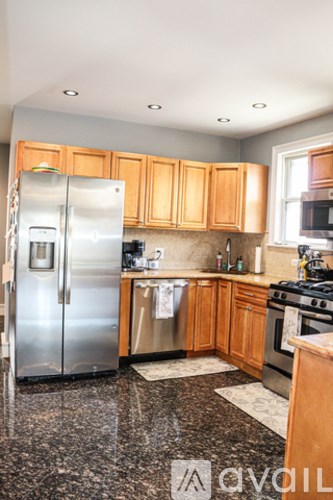 A kitchen with a refrigerator, stove, and microwave.