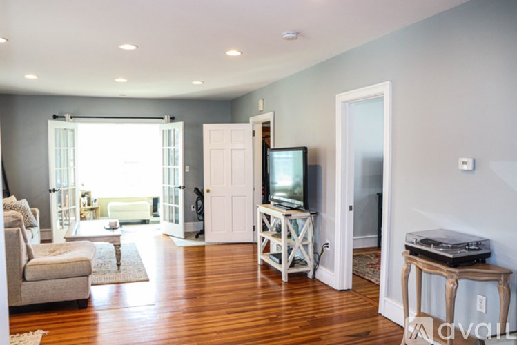 A living room with a television and a couch.