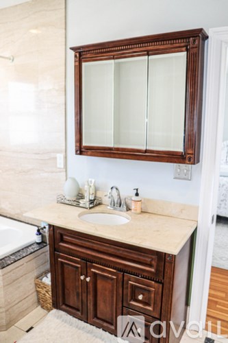 A bathroom with a sink and a mirror.