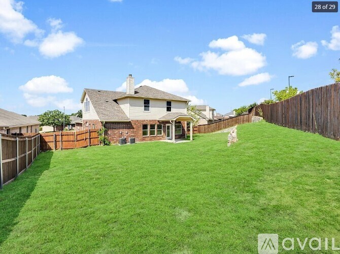 A house with a lawn and a dog in front of it.
