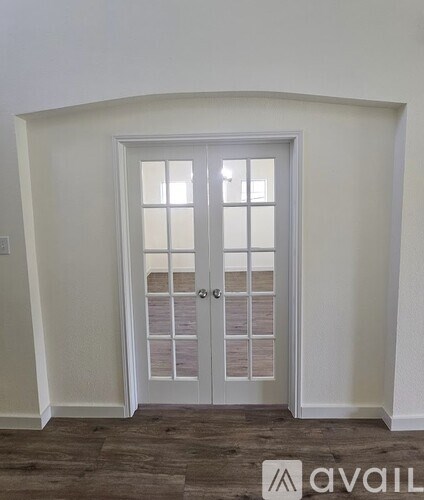 A white door with a glass panel and a handle.