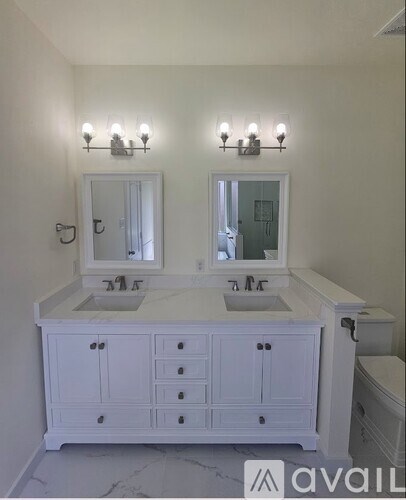 A bathroom with a vanity and a mirror.