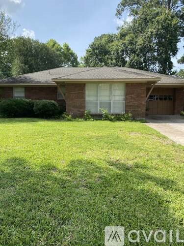 A house with a brown roof and a white garage door is for sale.