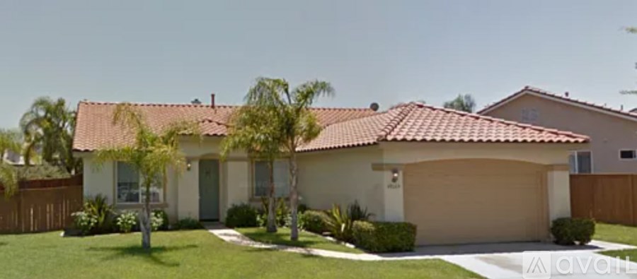 A house with a red tile roof and a garage.