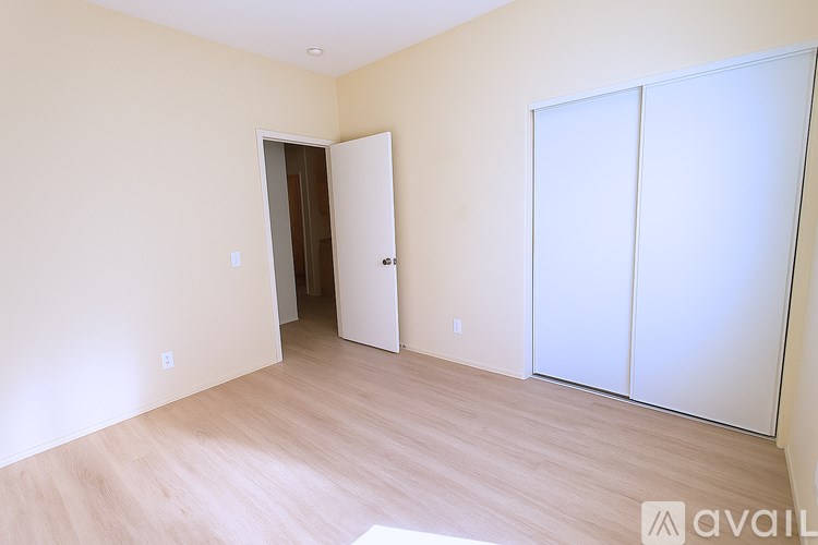 A room with a sliding door and a wooden floor.