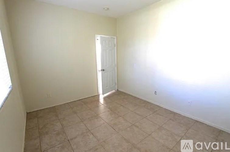 A room with a door and tiled floor.