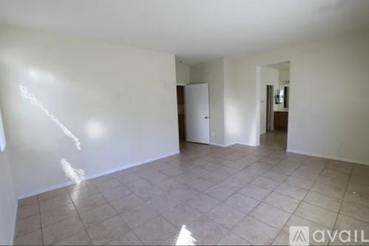 A room with a tiled floor and a white door.