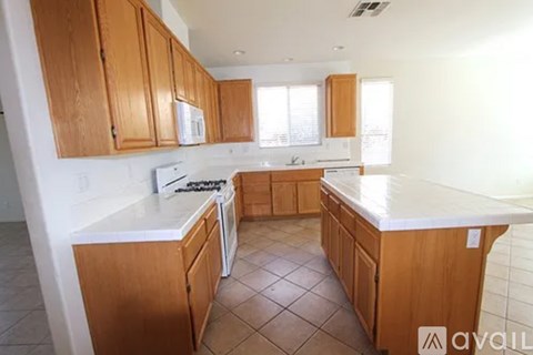 A kitchen with wooden cabinets and a white countertop.