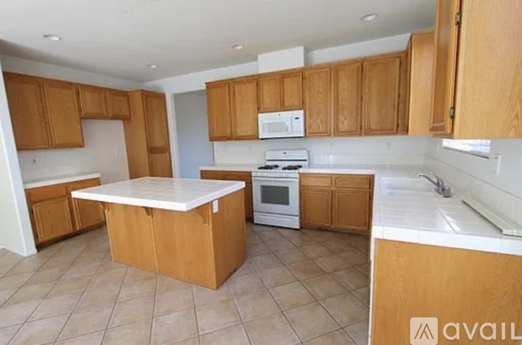 A kitchen with wooden cabinets and a white countertop.