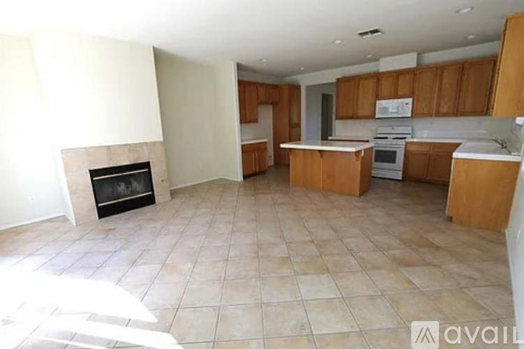 A kitchen with wooden cabinets and a tiled floor.