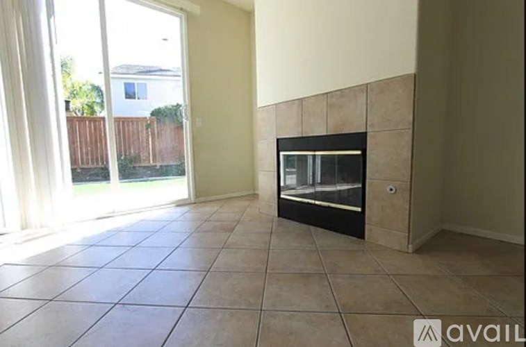 A room with a fireplace and tile flooring.