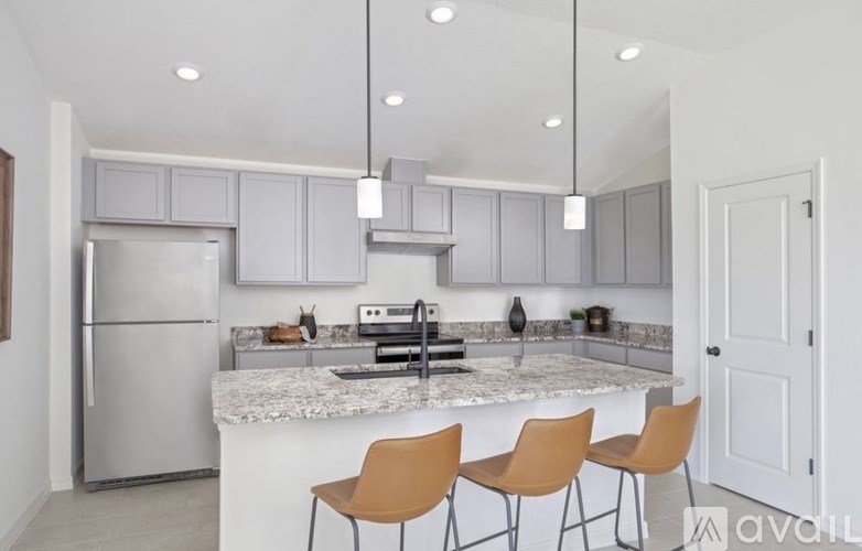 A kitchen with a marble countertop and modern appliances.