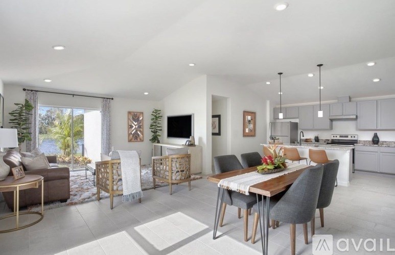 A modern dining room with a wooden table and chairs.