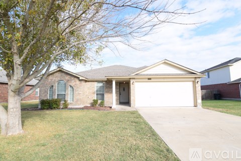 A house with a tree in front of it.