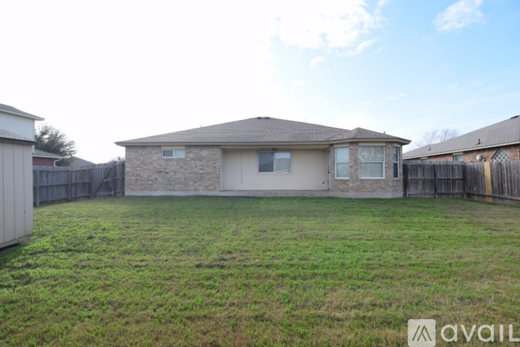 A house with a fenced backyard is for sale.