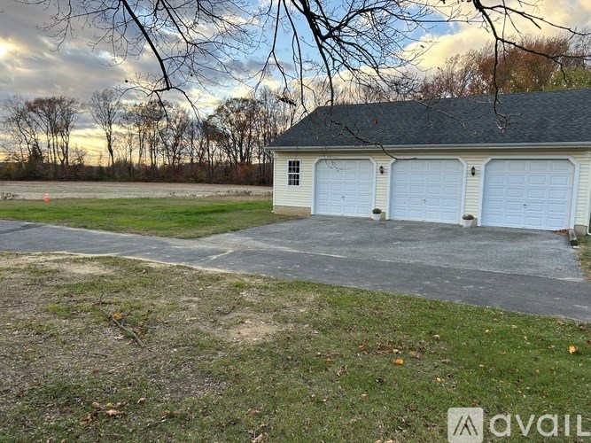 A house with a large garage is available for sale.