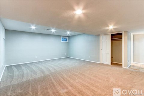 A room with a light blue wall and a wooden floor.
