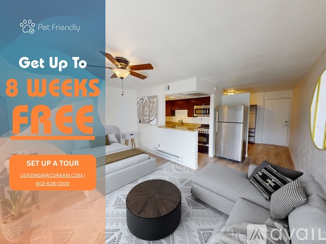 A living room with a couch, a coffee table, and a ceiling fan.